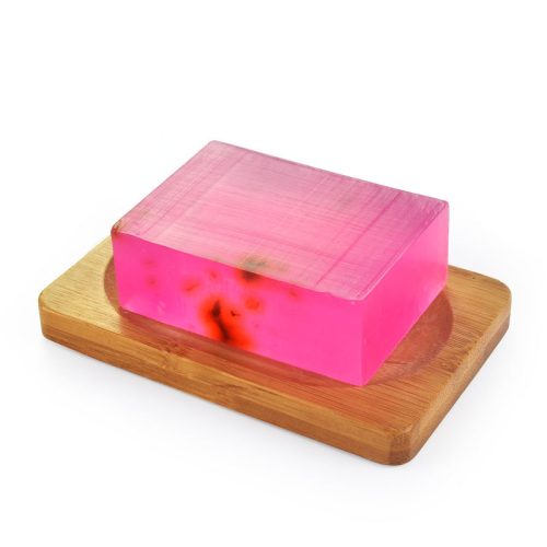 A pink soap bar placed on a wooden tray, highlighting a stylish and natural bathroom decor element.